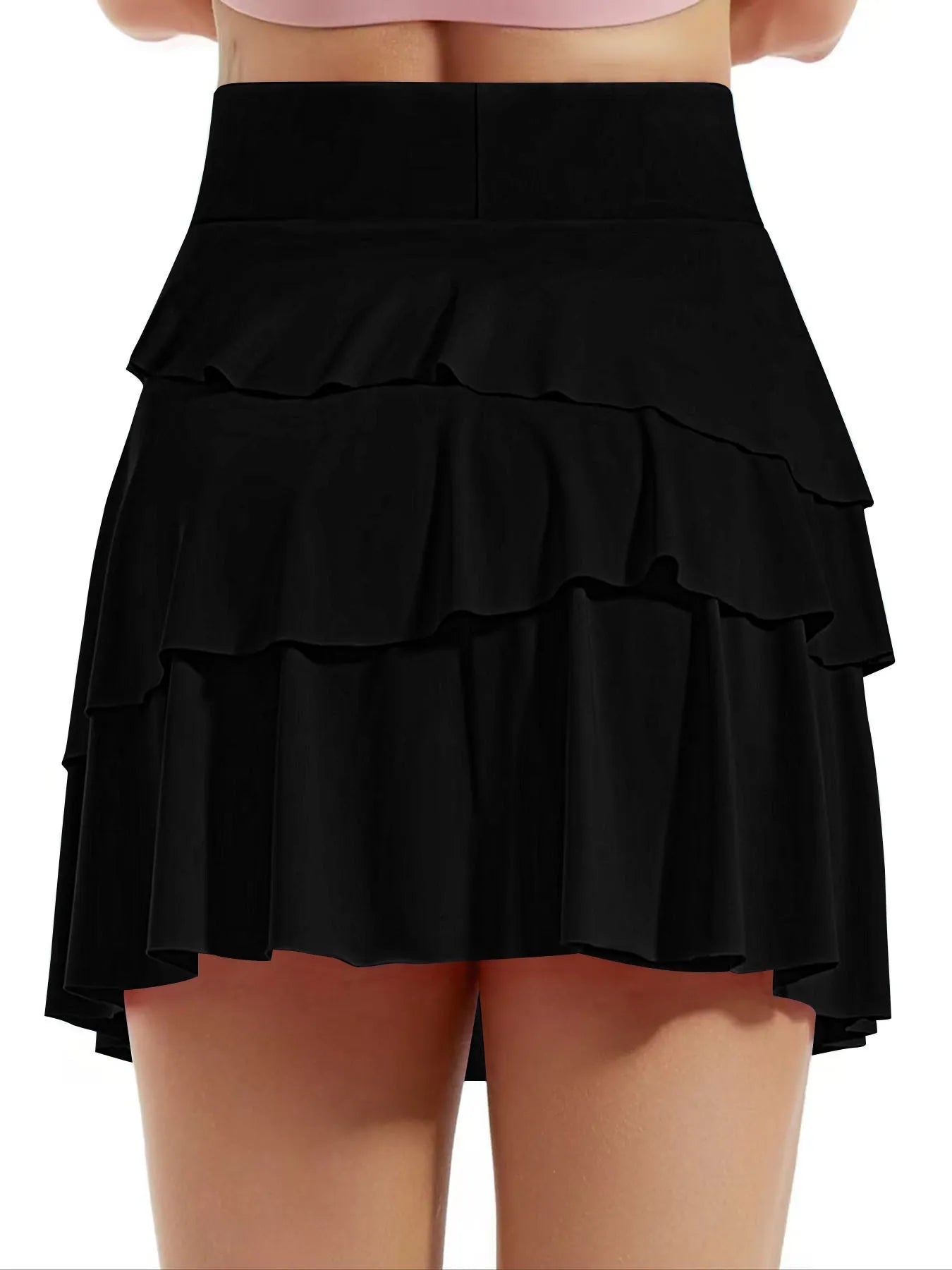 Black tiered skirt worn by a person on a white background