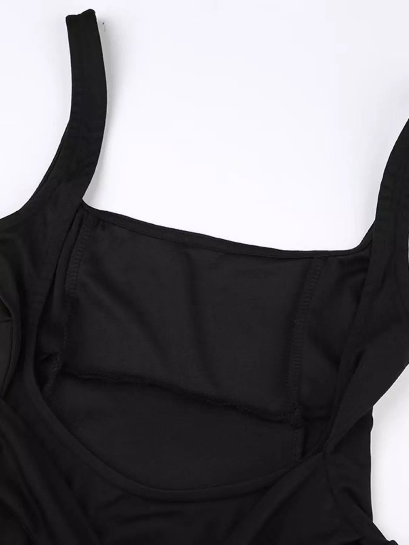Black swimsuit top on a white background
