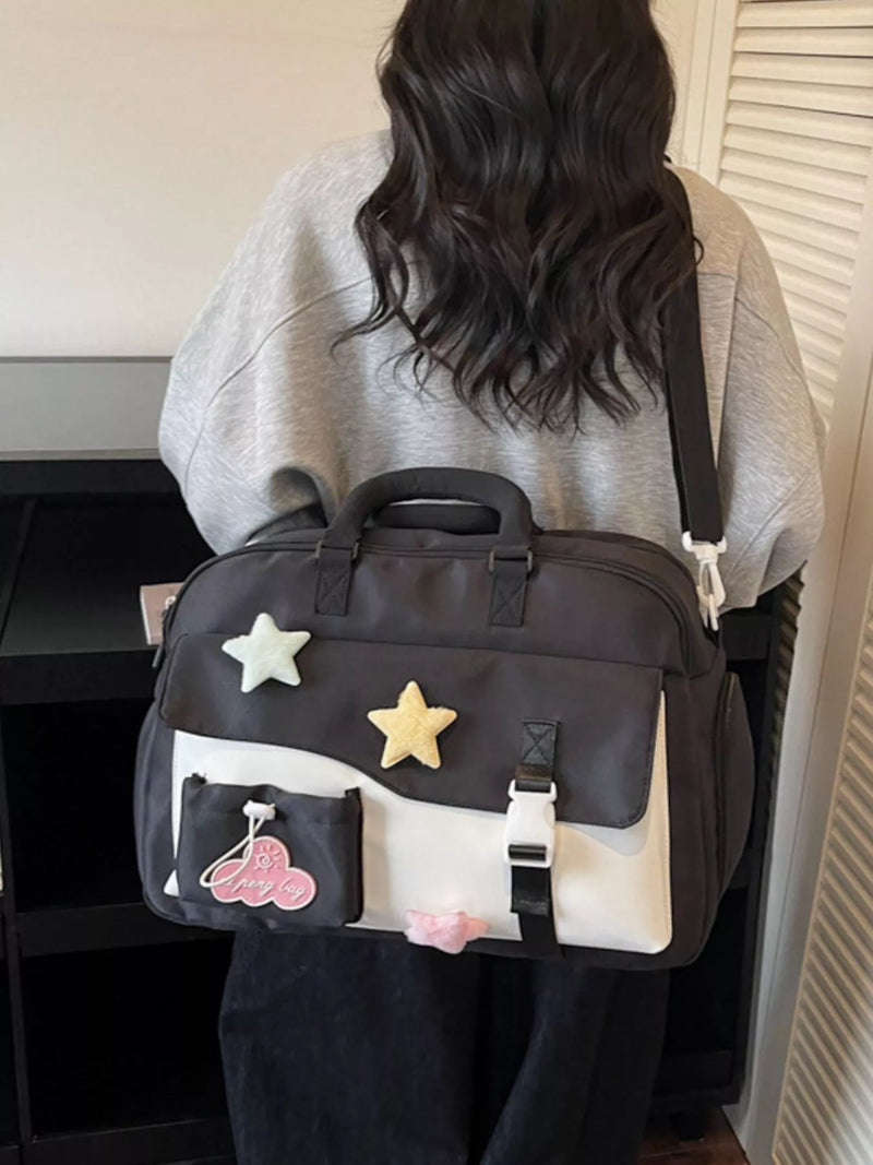 Person wearing a black bag with star and cloud designs