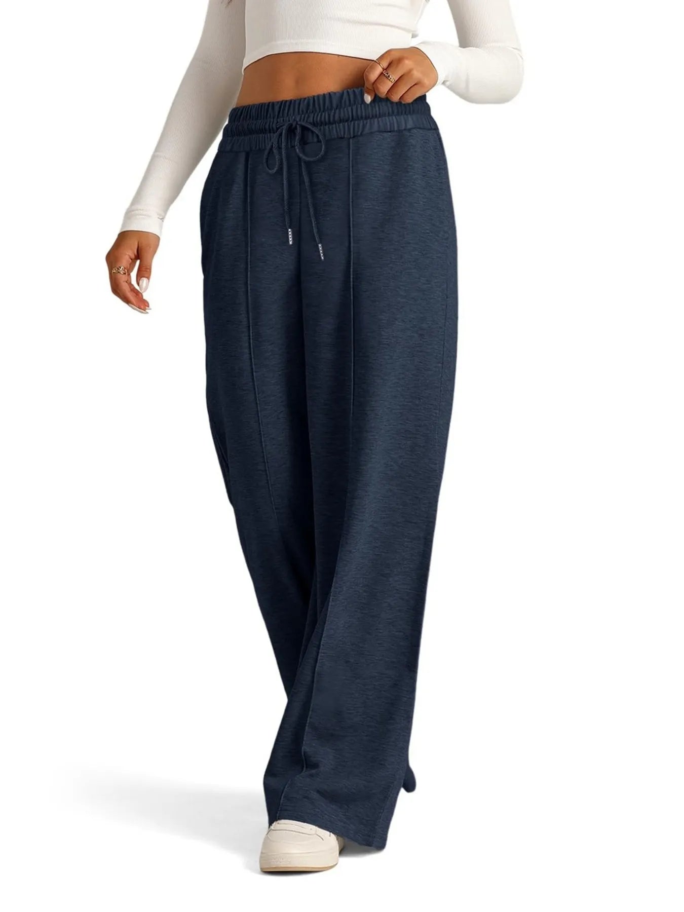Navy blue sweatpants worn by a person on a white background
