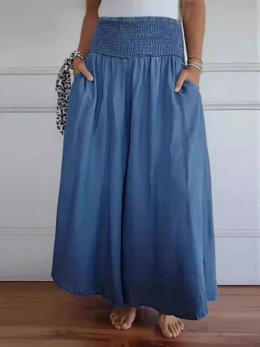 Person wearing a blue skirt with a white background