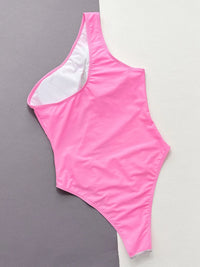 Pink one-piece swimsuit on a gray and white background