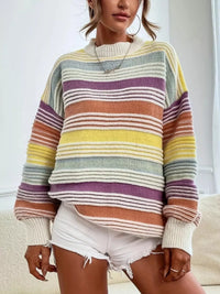 Person wearing a colorful striped sweater with a neutral background