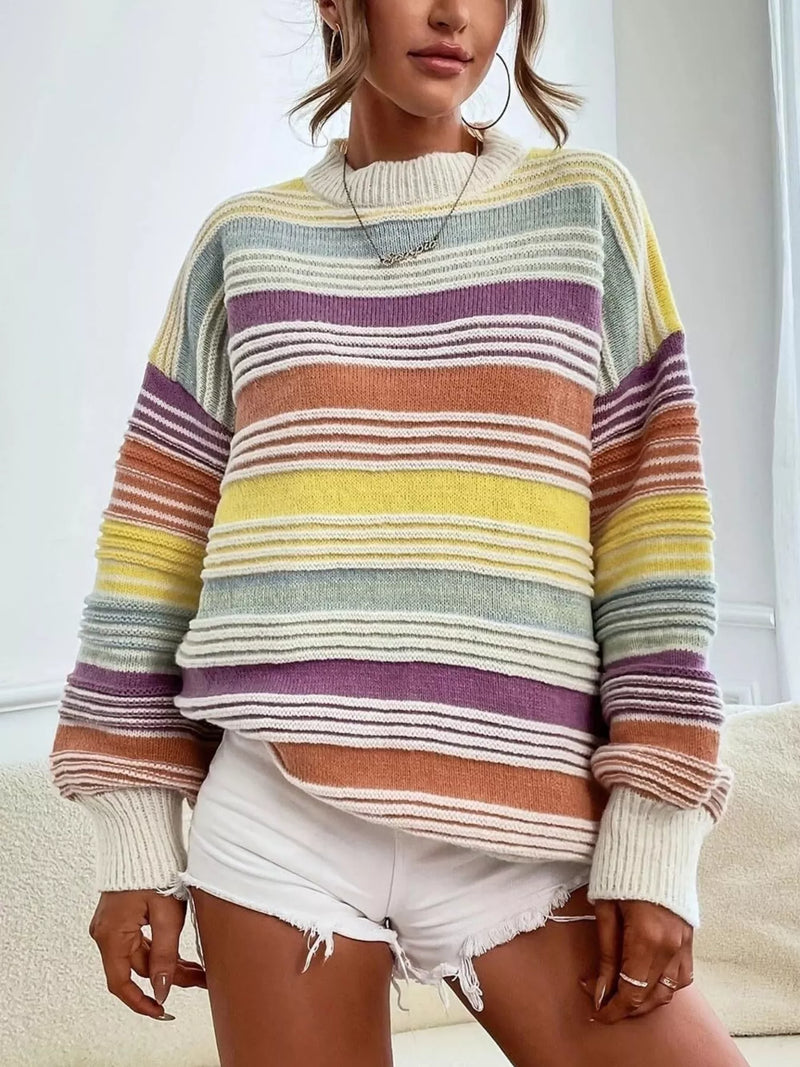 Person wearing a colorful striped sweater with a neutral background