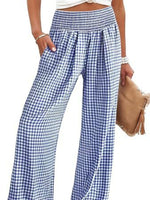 Blue and white checkered pants worn by a person on a white background