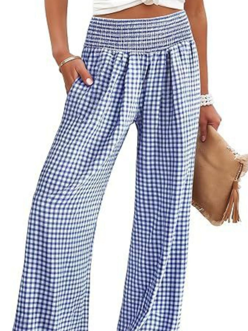 Blue and white checkered pants worn by a person on a white background