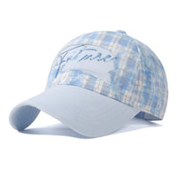 Light blue plaid cap with embroidered text on a white background