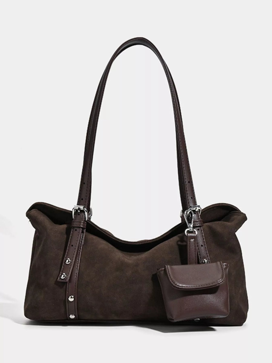 Brown handbag with a smaller attached pouch on a white background