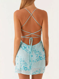 Light blue floral dress with criss-cross back straps on a white background