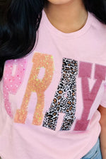 Pink t-shirt with colorful text design featuring glitter and leopard print.