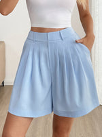 Light blue shorts worn by a person indoors.