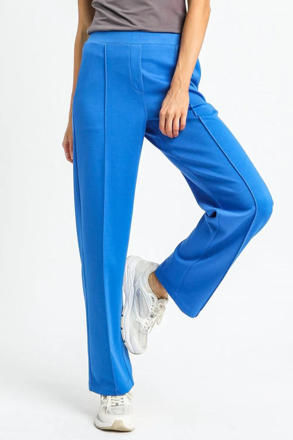 Blue pants worn by a person on a white background