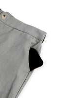 Gray pleated skirt with a button on a white background