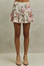Floral skirt worn by a person on a neutral background