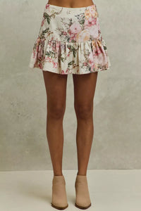 Floral skirt worn by a person on a neutral background