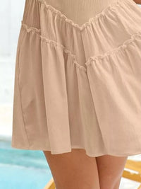Beige skirt with ruffled details on a blurred background