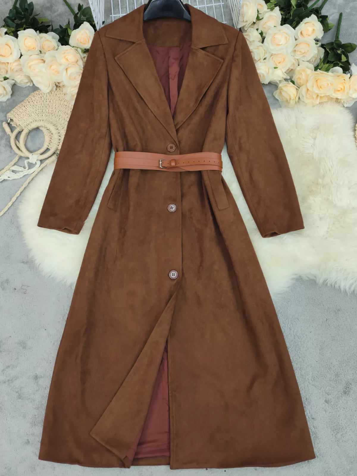Brown coat with a belt on a neutral background