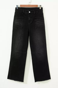 Black jeans on a hanger against a white background