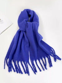 Blue scarf with tassels on a white background