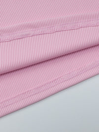 Close-up of pink fabric with a light gray background