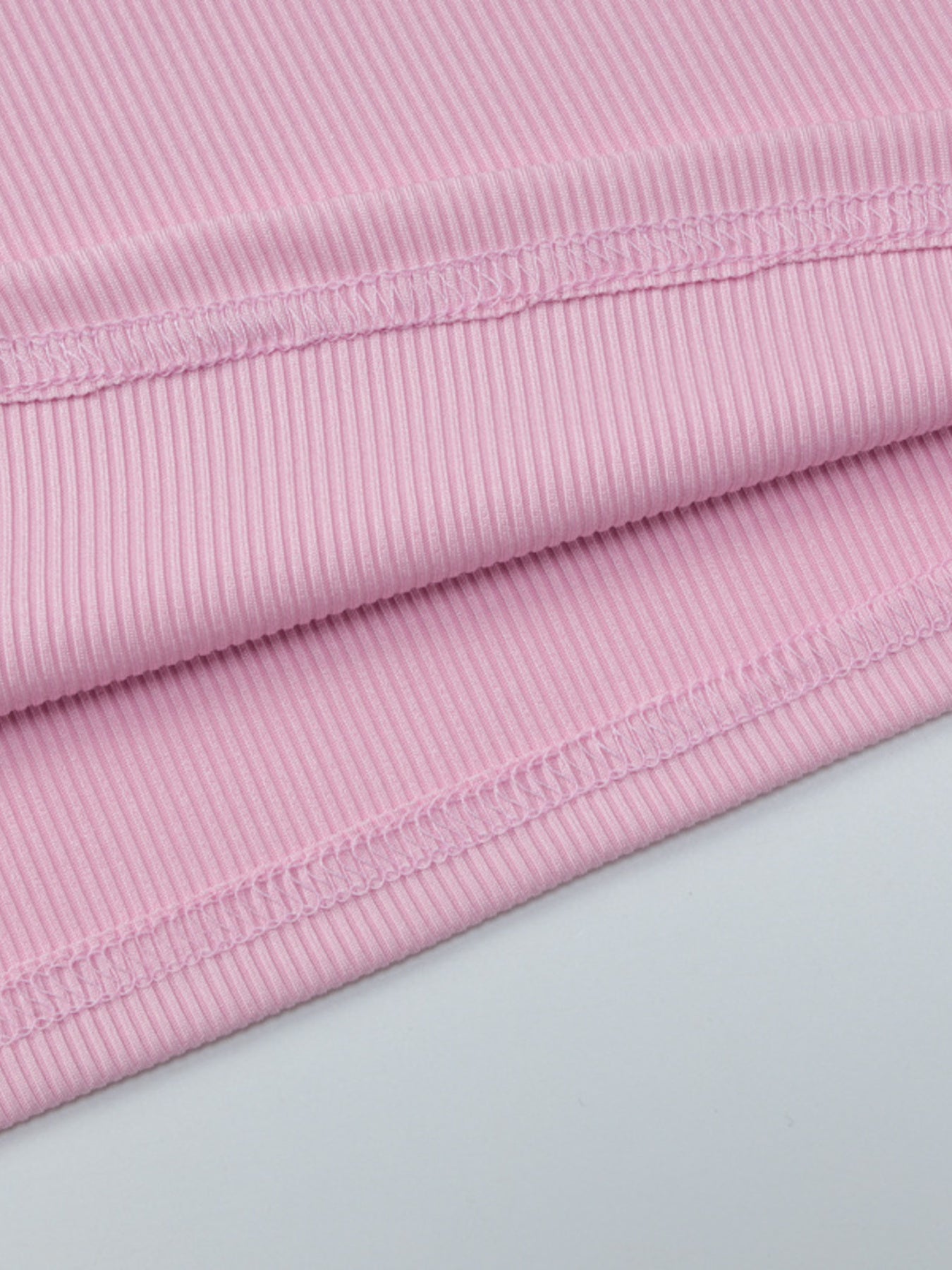 Close-up of pink fabric with a light gray background