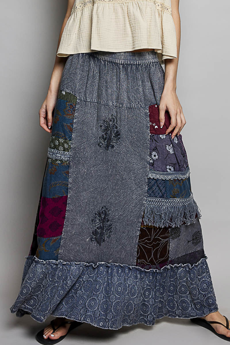 Long patchwork skirt with floral patterns on a plain background