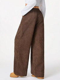 Brown wide-leg pants worn by a person on a white background