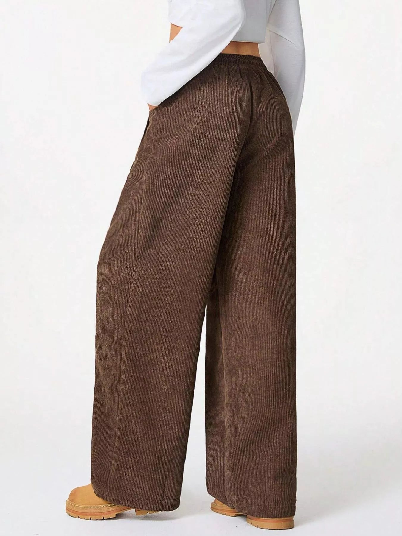 Brown wide-leg pants worn by a person on a white background