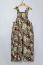 Camouflage overalls on a hanger against a plain background