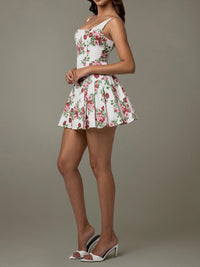 Woman wearing a floral dress against a plain background
