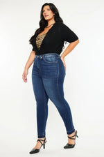 Woman wearing blue jeans and a black top with a leopard print detail on a white background