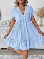 Woman wearing a light blue dress in a home setting