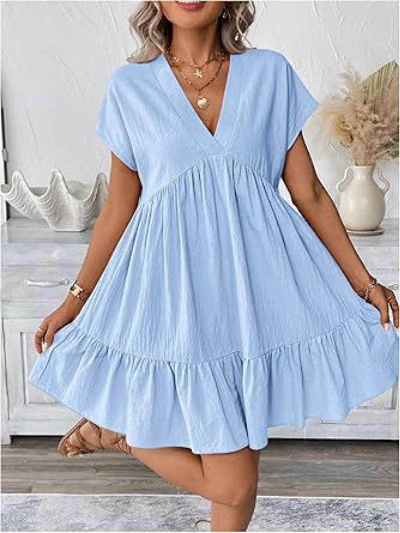 Woman wearing a light blue dress in a home setting