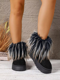 Black fur-trimmed boots on a neutral background