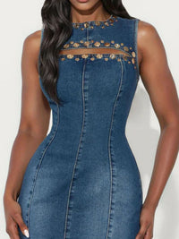 Blue denim dress with gold embellishments on a white background