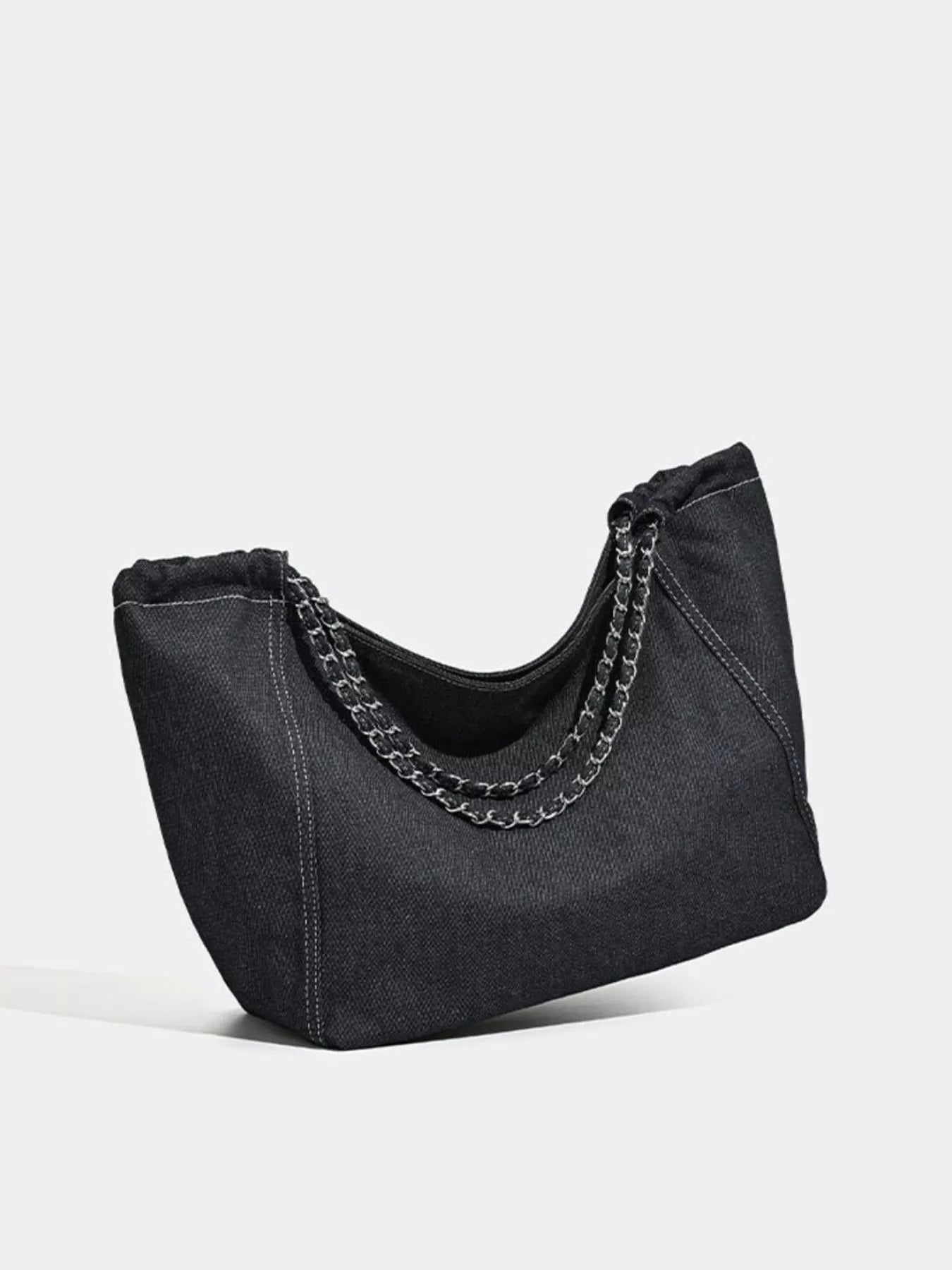 Black handbag with chain detail on a white background