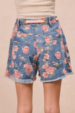 Floral denim shorts on a plain background
