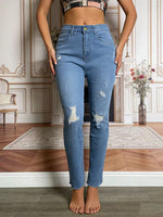 Person wearing blue jeans in a room with decorative elements