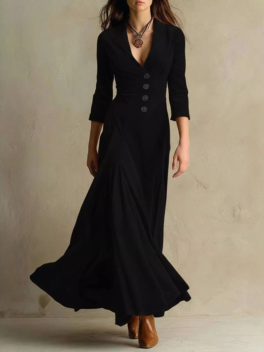 Woman wearing a long black dress with a plain background