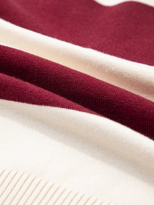 Close-up of maroon and beige fabric with a textured background