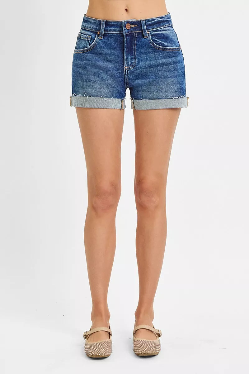 Denim shorts worn by a person on a white background