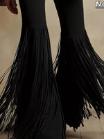 Black fringe pants on a neutral background