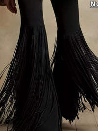 Black fringe pants on a neutral background