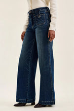 Person wearing blue jeans on a white background