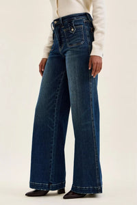 Person wearing blue jeans on a white background
