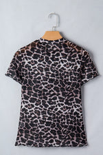 Leopard print dress on a hanger against a light gray background