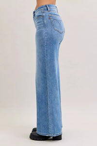 Light blue jeans worn by a person on a white background