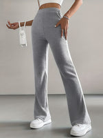 Person wearing gray ribbed wide-leg pants with a white background