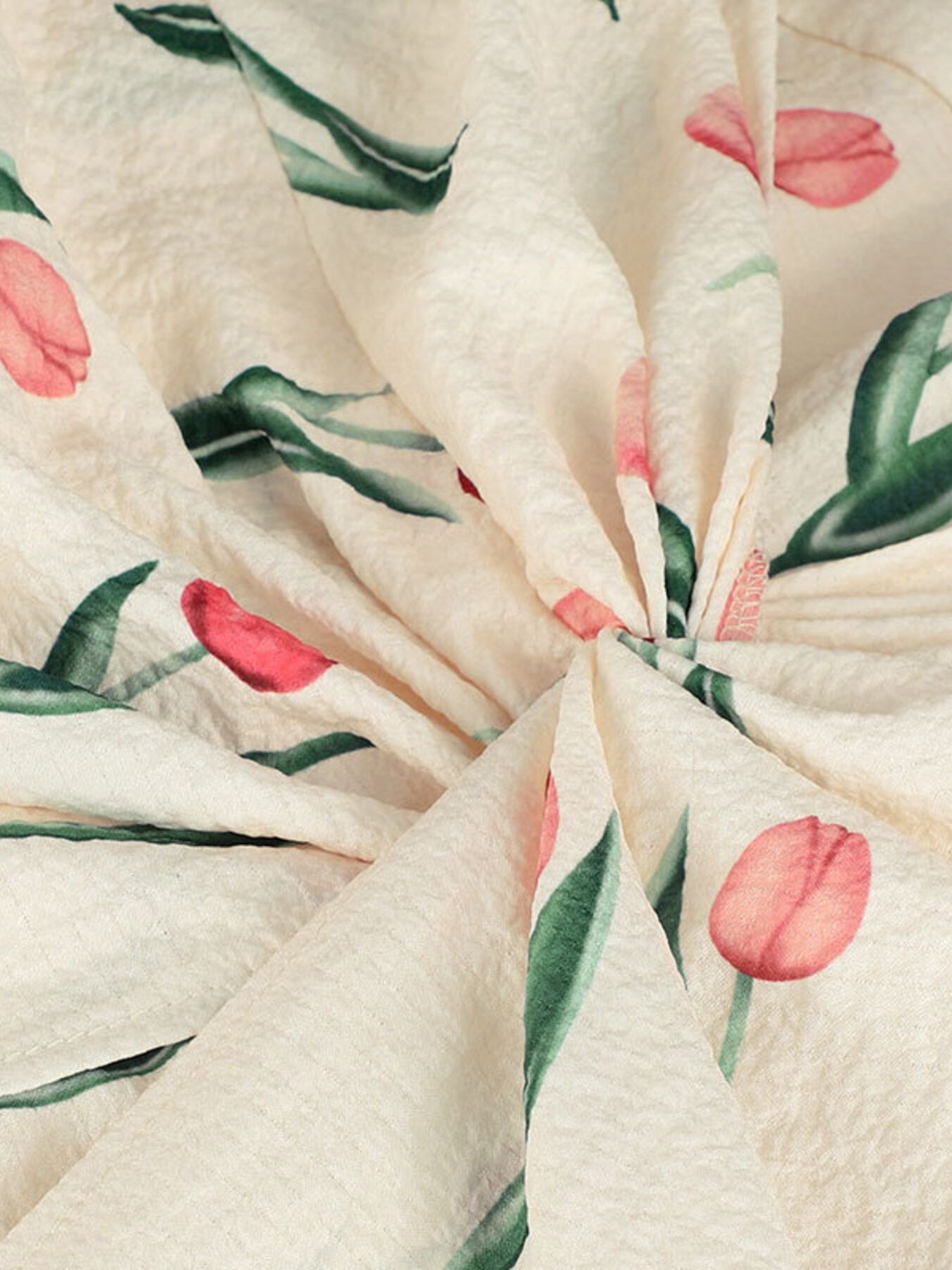 Close-up of fabric with pink tulip pattern