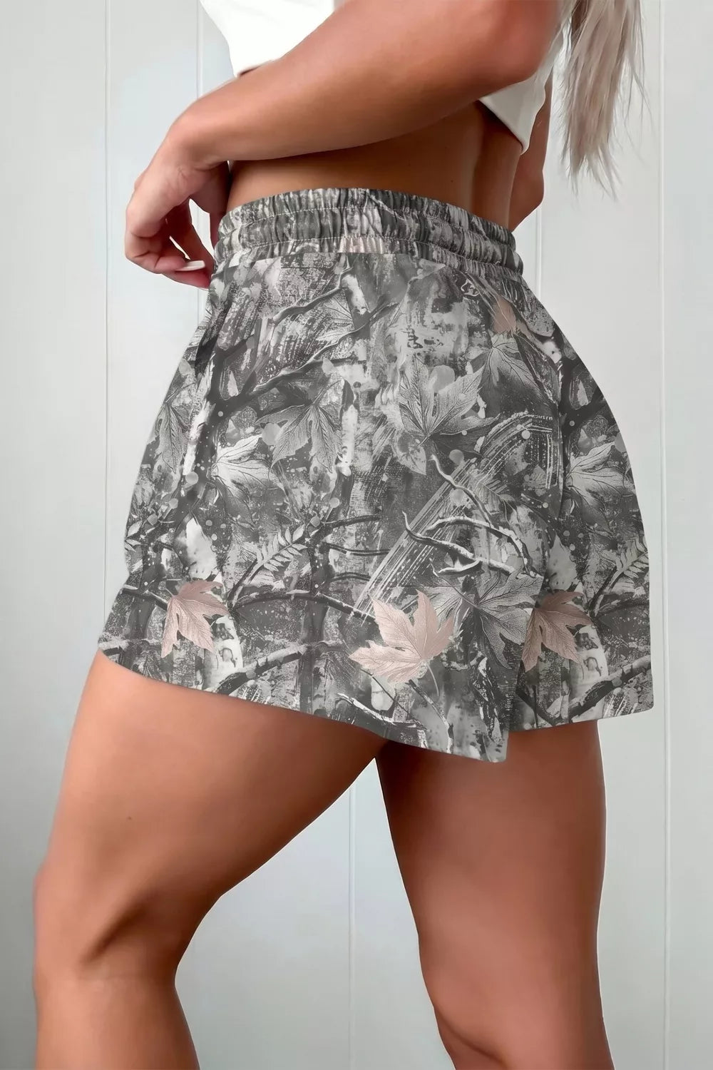 Floral patterned skirt worn by a person on a plain background